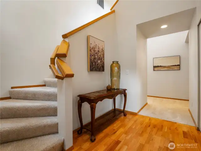 The entryway greets you with soaring ceilings and bright windows.
