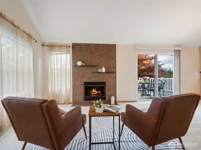 The large living room features a beautiful gas fireplace and large windows all around.