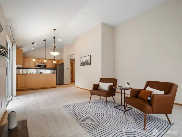 The vaulted ceilings and fresh paint in this great room add to its airy brightness.