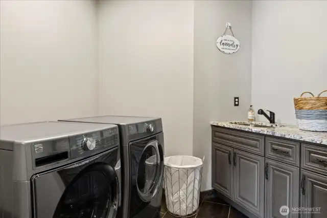 Generous mudroom off garage entry with utility sink.