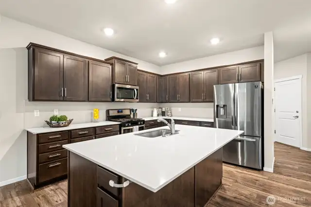 A central gathering point, the oversized quartz island is perfect for casual dining, meal prep, and hosting—creating the heart of the home