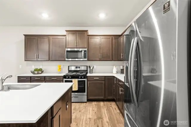 Whip up meals with ease using the sleek gas range and built-in microwave, with everything you need close at hand in this well-organized space