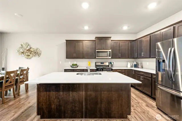 Gather, cook, and entertain in style showcasing espresso luxurious cabinetry