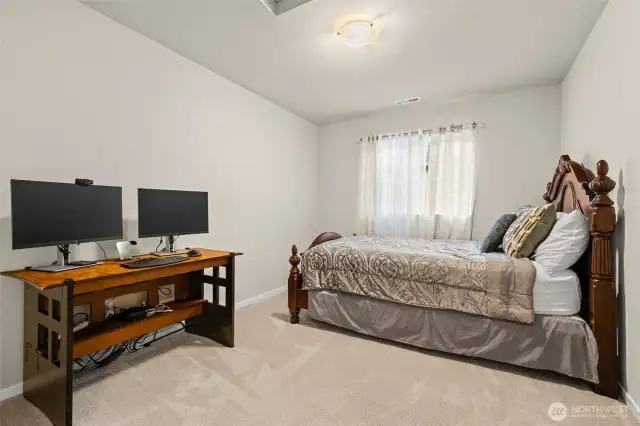 Spacious upstairs bedroom includes a large window and a full closet, perfect for everyday comfort or flexible use