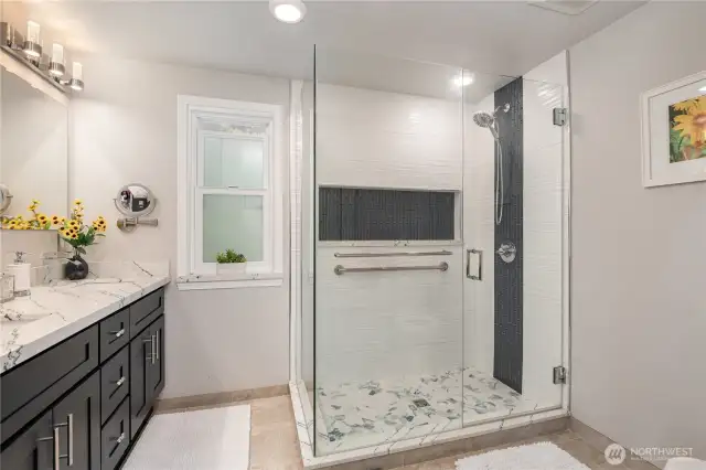 En-suite primary bathroom offers a large walk-in shower.