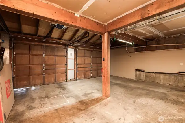 Large two-car garage features modern upgrades including generator readiness and an EV charger, offering both peace of mind and convenience.