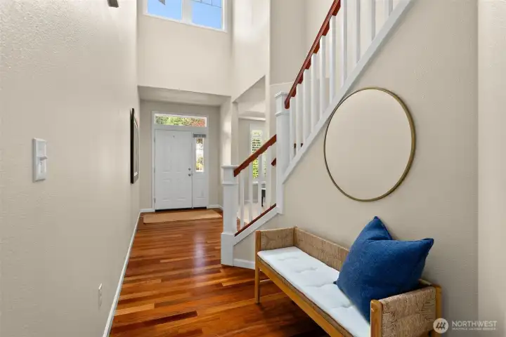 You'll notice here the large window above the entry also sets the tone for the bright natural light throughout this special home.