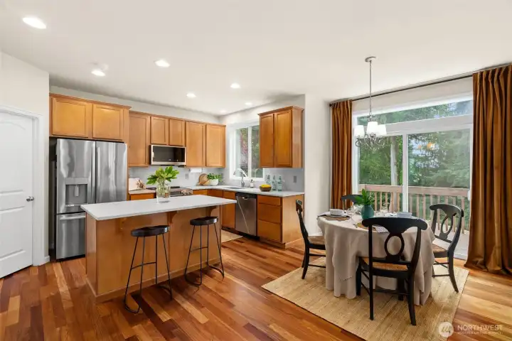 In the heart of the home, the refreshed kitchen features stunning quartzite countertops, newer stainless steel appliantes, and complimentary tile backsplash. The view from the kitchen sink is into the back yard and greenbelt facing East.