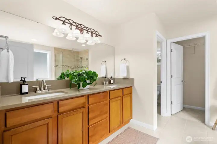 The primary bathroom has an ensuite with water closet, walk-in closet, soaking tub and custom-tiled shower.