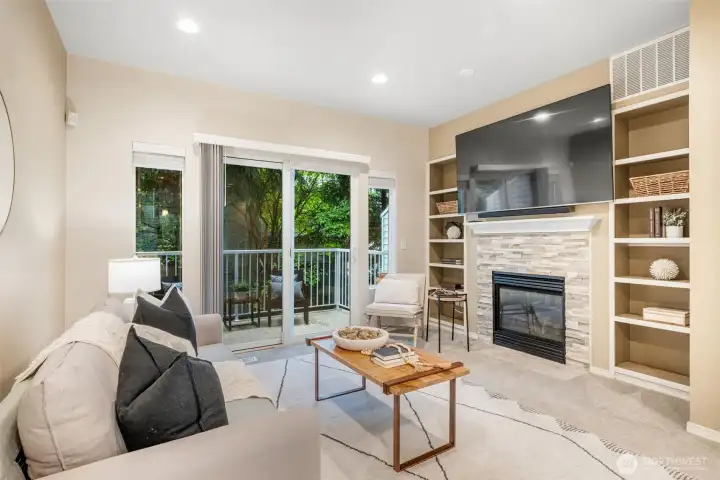 Gas fireplace with tiled surround, built-in shelving, w/ TV & surround sound