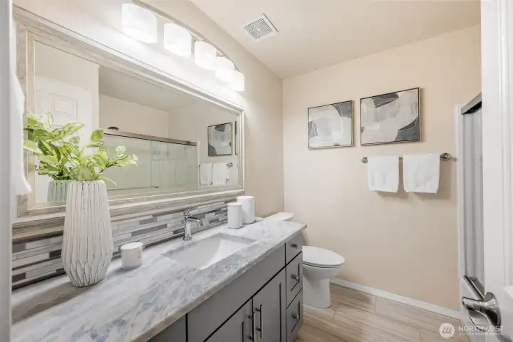 New vanity, countertops, flooring, & shower surround