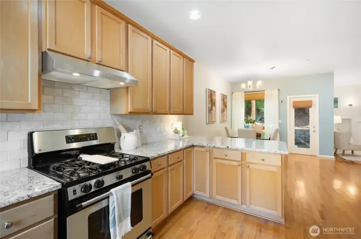 Full-height custom backsplash enhances kitchen elegance.