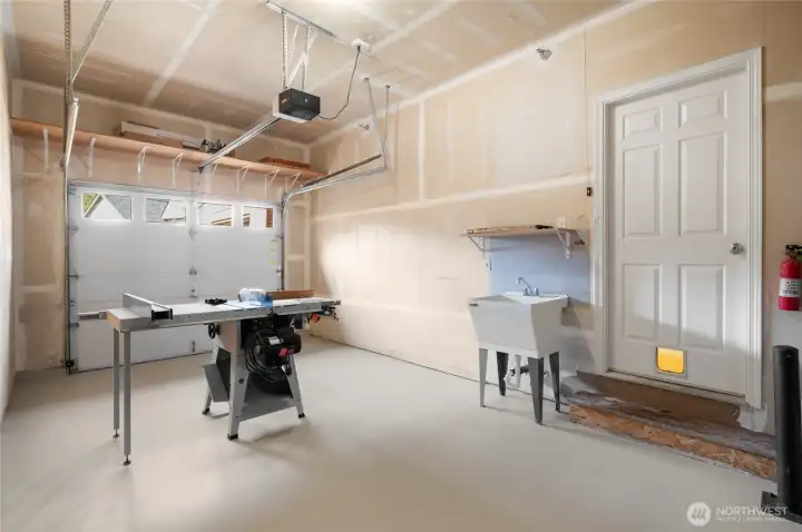 Garage bay/ home gym option, with convenient utility sink.