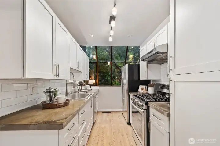 Crisp, updated subway tile backsplash enhances the kitchen design