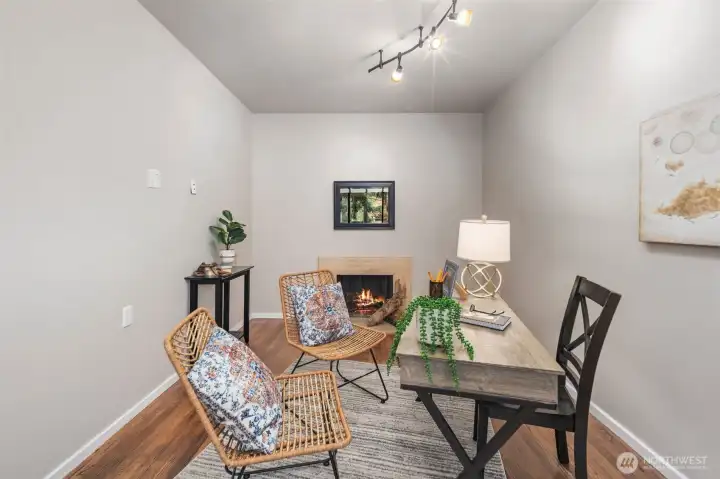 Work from home space enhanced by a traditional wood burning fireplace.