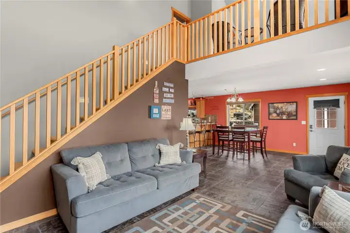 Main floor living room, stairs to Primary bedroom and loft