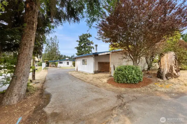 Lot is just shy of a 1/4 acre level.  Plenty of parking in the driveway, additional covered storage attached to the garage.