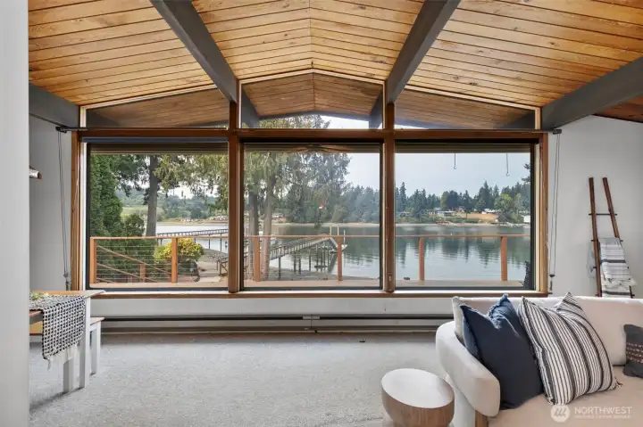 Living room offers floor to ceiling views of the bay.