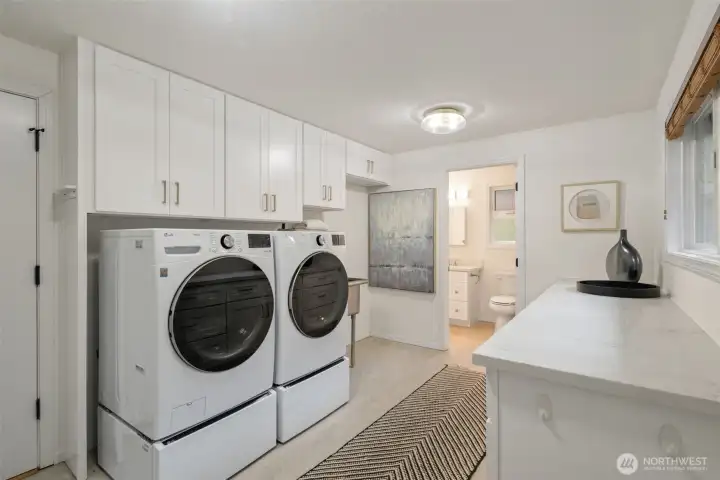 Large laundry/mudroom 0ff garage, 3/4 bath in background