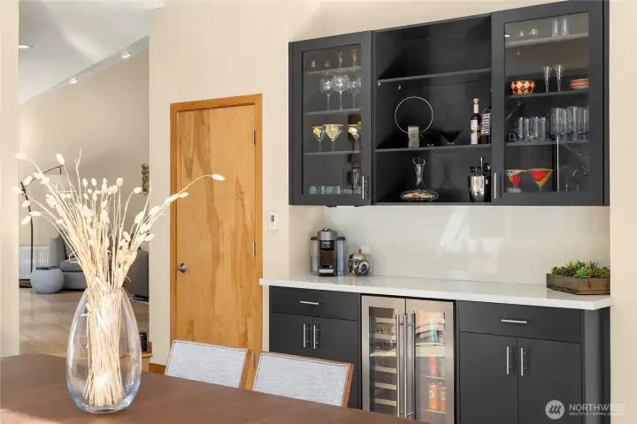 A convenient wet bar is in the kitchen and dining space to give you even more artful storage and a handy beverage fridge.