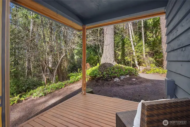 The deck off the primary bedroom overlooking the peaceful and private natural surroundings.