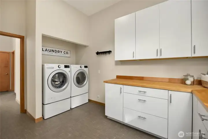 Next to the half bathroom is the spacious laundry room. The quality LG washer and dryer convey and cabinetry and countertops were recently installed for nice style and storage space.