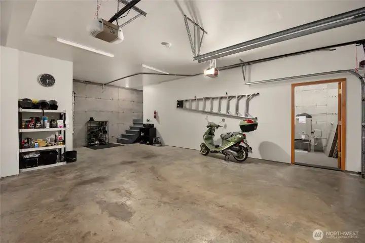 Moving down to the garage you find a tidy finished 2-car garage and an adjacent shop space.