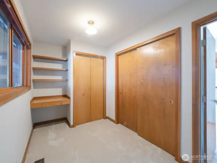 Bedroom 2 on main floor with built-in desk and shelving