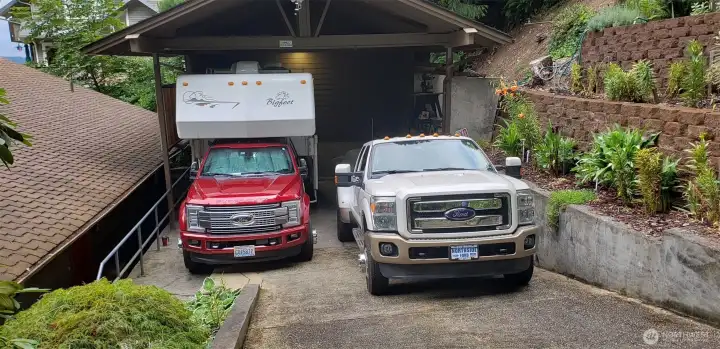Drive into the detached oversized 2+ carport and easy hammer-head turn around for extra parking. Storage and separate office in the back of carport,  Carport can accommodate RV storage and the carport also has 240 V utility box for RV. Built in stereo system and security system.