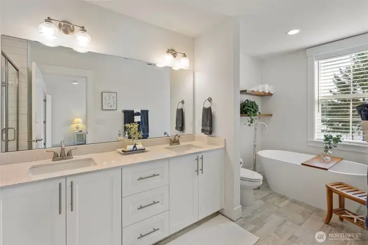 Primary bath with quartz contertips, soaking tub and subway tiled shower.