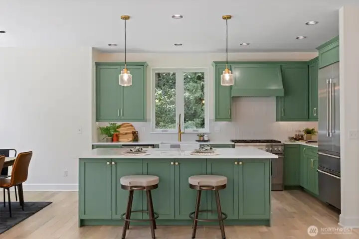 Designed with intention and built to impress, the home showcases a chef’s kitchen with Thermador appliances, wine fridge, and walk-in pantry.