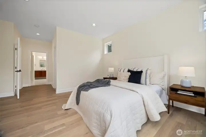 Luxurious primary on the main level offers a very generous walk-in closet and en-suite bath.