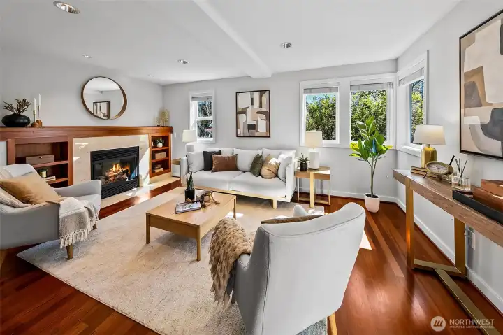 Welcome home! Main floor living room with Brazilian cherry hardwood floors, cozy gas fireplace and corner SW facing windows invite the light throughout.