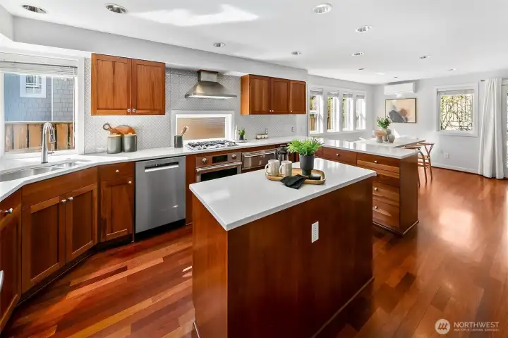 Updated kitchen shines with corner windows, tons of counter space, beautiful cabinets and gas cooktop. Bright dining room with French doors leading directly to the backyard patio garden.