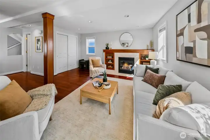 Gorgeous details in the living room with cherry hardwood floors, cozy gas fireplace and display shelves.