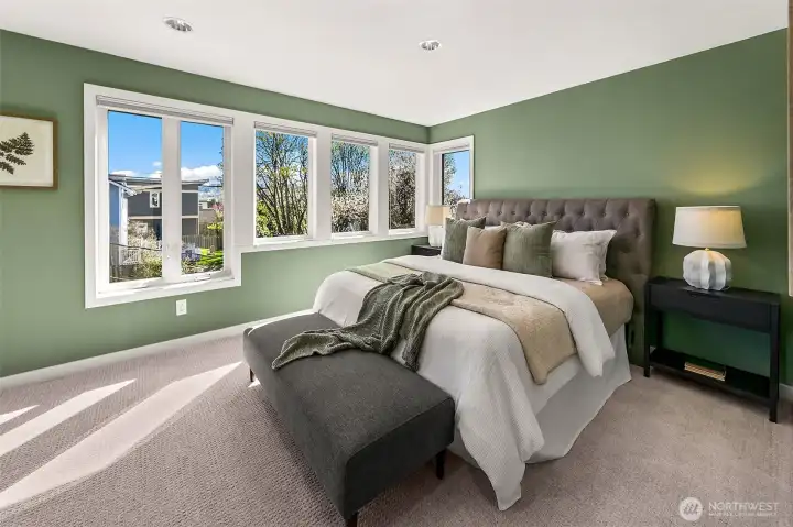 Light and bright, spacious primary suite with big windows and water views.