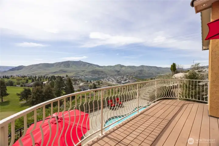 Expansive view deck perfectly positioned to capture breathtaking panoramic vistas of Lake Chelan, the surrounding mountains, and the lush golf course below. This inviting outdoor space offers the ideal setting for morning coffee or evening relaxation, where you can take in sweeping scenery and unforgettable sunsets. With ample room for seating and entertaining, the deck seamlessly extends the living space into the beauty of the outdoors.