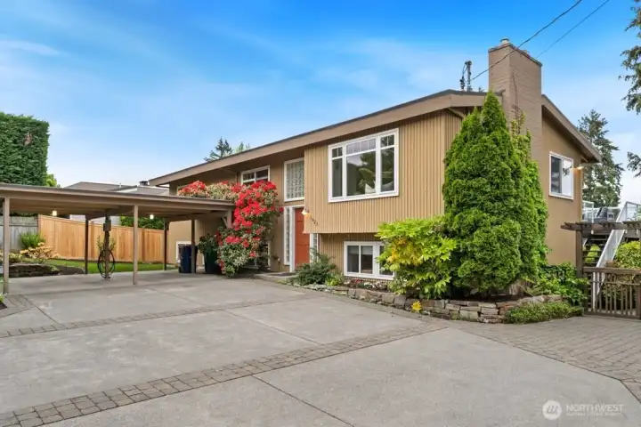 Large two car carport with EV charger and additional parking features a new black top driveway plus cement and brick pavers. Large two car carport with EV charger and additional parking features a new black top driveway plus cement and brick pavers.