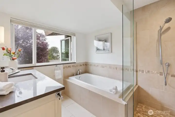 Primary en-suit spa-inspired bath featuring heated floors, walk-in shower and soaking tub Primary en-suit spa-inspired bath featuring heated floors, walk-in shower and soaking tub