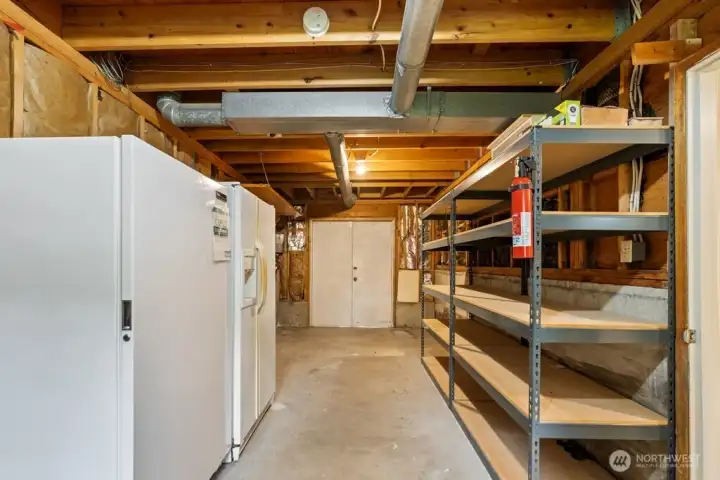 Full size shop on lower level with tons of storage areas and backyard access Full size shop on lower level with tons of storage areas and backyard access