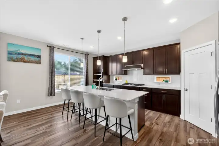 Enjoy informal dining at your quartz counter island with pendant lighting.  Thoughtfully designed corner pantry