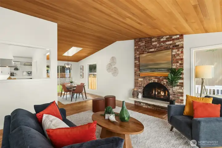 The living room, dining room and kitchen are designed to create a warm gathering space around the views and gas fireplace