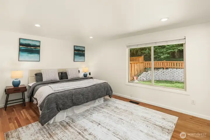 Large primary bedroom with great closet space overlooking the private backyard