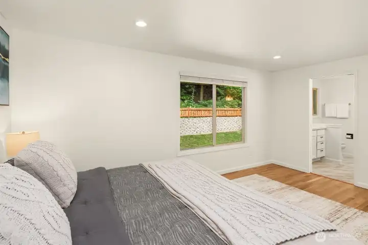 Large primary bedroom with great closet space overlooking the private backyard
