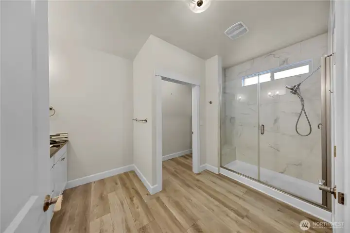 Primary bath with large walk in shower with gorgeous tile work