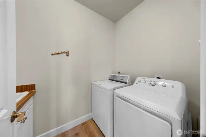 Full service laundry room with utility sink and folding table - located off main living and conveniently located next to primary bedroom