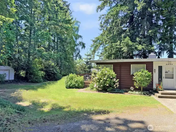 The south part of the yard with the 12x23 deck. Ideal for BBQ's. This part of the yard has hosted many family games of croquette, badmintion and boccci ball. With easy access to the deck that is slightly above the yard, it is ideal for entertaining and BBQ's