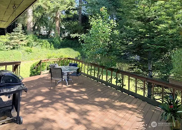 You can see how the deck overlooks the yard. It's an awesome place to hold outdoor parties and BBQ's. Mature landscaping includes Rhody's. Mock Orange bush, Lilacs, Hydrangeas, fir, holly, pine tees and other plants help make the house and yard mostly private.