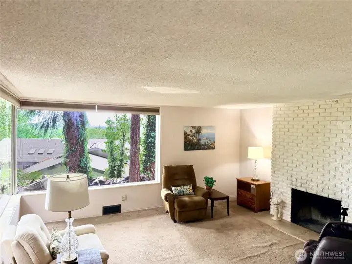 The room is spacious enough for a variety of furniture placement. The wood burning fireplace adds ambience to the space.
