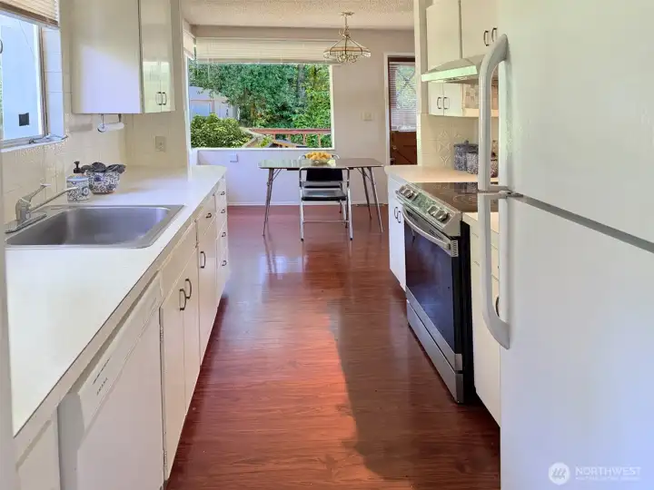 This kitchen while a bit on the smaller size was adaquate for a family raising 5 children here. There is additional counter space and cupboards you will see in other photos that offers additional working and storage space that offsets the smaller kitchen space.